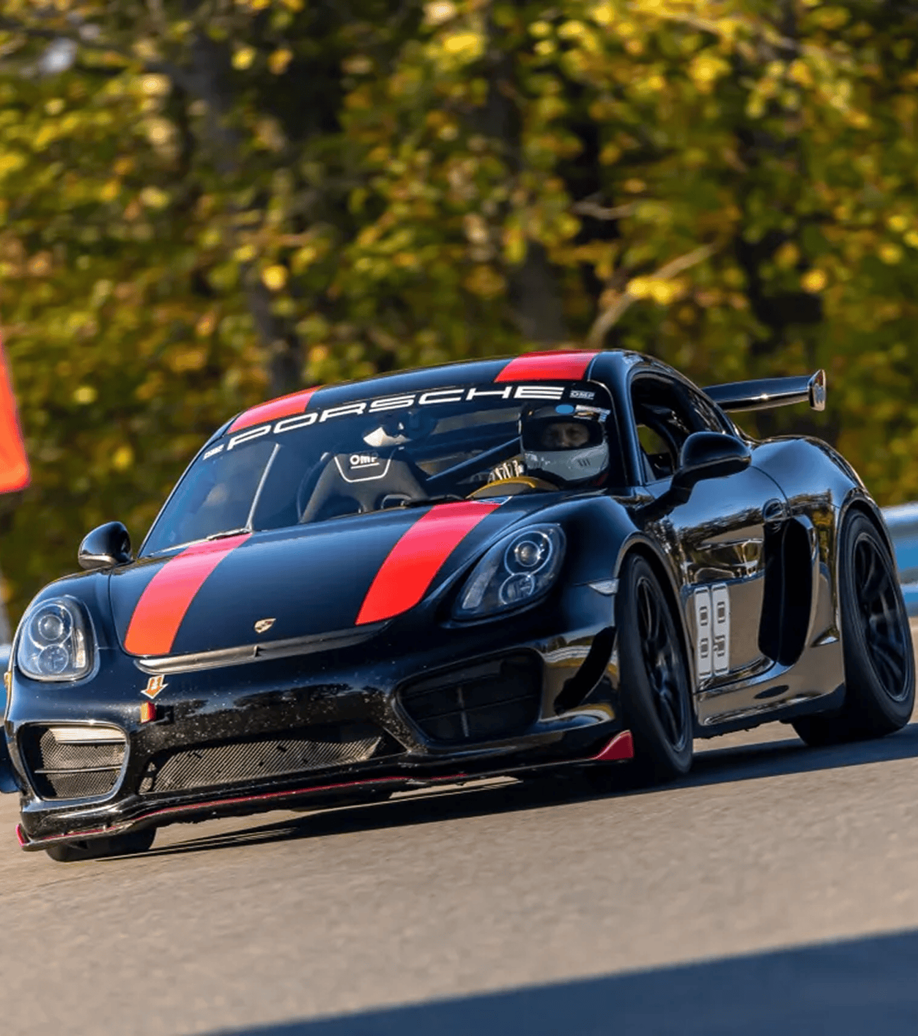 Black Porsche race car on the track.